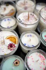 A set of different aroma Soy and coconut wax candles in glass jars. Scented candle. Natural essential candles in a Amber jar. Aromatherapy, wellness and relax in spa product. Close up.