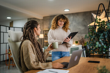 two females colleagues work together on new project at home office