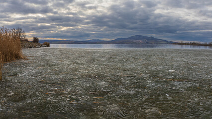 Winter ice season. Frozen lake and view of Palava landscape