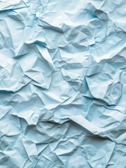 Obraz premium This image showcases a close-up of crumpled blue paper, highlighting its texture and vibrant color, perfect for creative design projects and backgrounds.