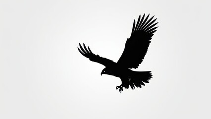 Obraz premium Black silhouette of a soaring bird with wide-spread wings against a light background.