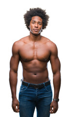 Fototapeta premium Afro american shirtless man showing nude body over isolated background with serious expression on face. Simple and natural looking at the camera.