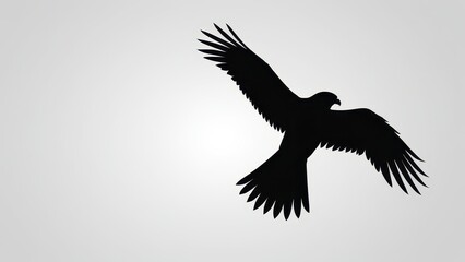 Fototapeta premium Silhouette of a flying eagle, symbolizing strength and freedom in minimalist design.