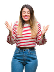 Young beautiful woman casual stripes winter sweater over isolated background celebrating mad and crazy for success with arms raised and closed eyes screaming excited. Winner concept