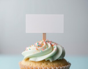 Delicious pink cupcake with smooth frosting swirl, sprinkles, and blank flag for design projects.