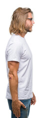 Young handsome man with long hair wearing glasses over isolated background looking to side, relax profile pose with natural face with confident smile.