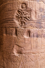 Agilkia Island, Aswan, Egypt. Christian cross carved over Egyptian hieroglyphics on a column at the Philae Temple, a UNESCO World Heritage Site.