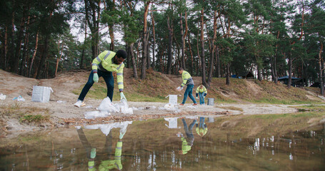 Working in clean up crew for big hotel or resort. Cleaning up polluted area with plastic waste...