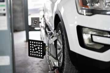 Close up of car wheel alignment in auto repair shop