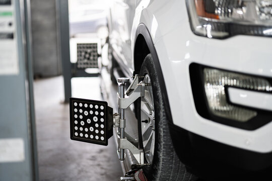 Close up of car wheel alignment in auto repair shop