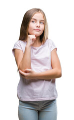 Fototapeta premium Young beautiful girl over isolated background with hand on chin thinking about question, pensive expression. Smiling with thoughtful face. Doubt concept.