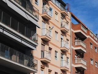 Facades of Diverse Modern Residential Buildings with Balconies in Barcelona on a Sunny Day with Clear Blue Sky