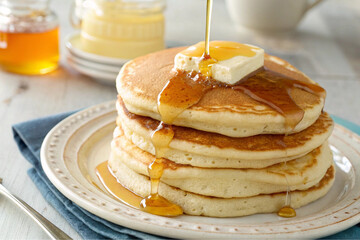 Delicious Stack of Buttery Pancakes Drizzled with Honey