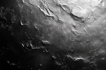 Fototapeta premium Uneven surface with shiny highlights and deep shadows creates a dramatic and textured backdrop