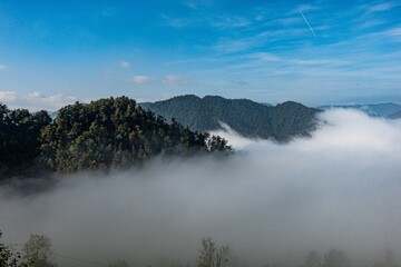 Beautiful view of the majestic Slovenia mountains covered in fog on a sunny day © Ignacio