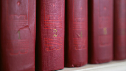 Close-up of a book on a bookshelf. Old hardcover books