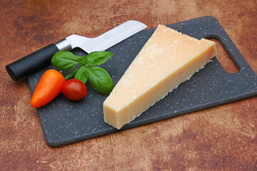 Parmesan cheese on a cutting board.