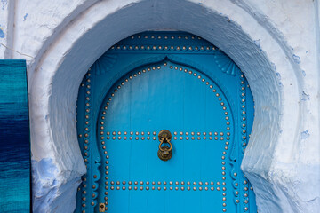 Africa, Morocco, Chefchaouen. Blue door with metal knocker.