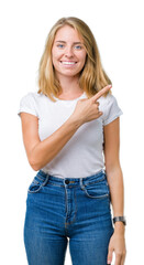 Fototapeta premium Beautiful young woman wearing casual white t-shirt over isolated background cheerful with a smile of face pointing with hand and finger up to the side with happy and natural expression on face