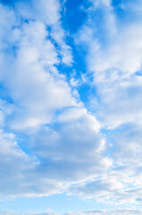 Blue sky view, picturesque blue sky background with scenic fluffy clouds, vertical blue sky...