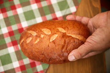 Closeup image of hands holding homemade sourdough bread, Craft authentic bread and Home Cooking Concept
