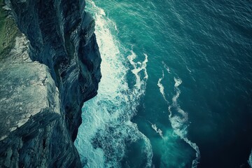 Majestic cliffs rise above the crashing waves of the ocean on a sunny day