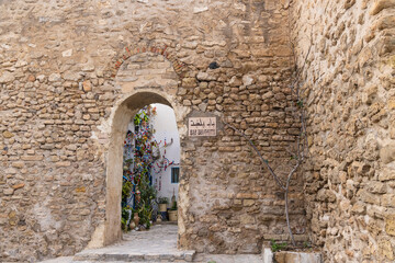 Hammamet, Nabeul, Tunisia. Doorway through a stone wall.