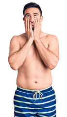 Fototapeta premium Young handsome man wearing swimwear tired hands covering face, depression and sadness, upset and irritated for problem