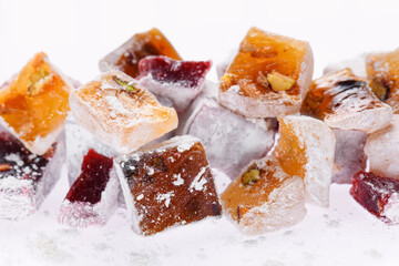 Sweet food Turkish delight, assorted rahat locum in form of cubes with nuts and powdered sugar, traditional food, on white background