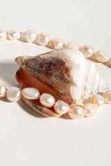 Pink pearl thread in seashell. Baroque pearls