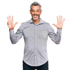 Middle age grey-haired man wearing casual clothes showing and pointing up with fingers number nine...