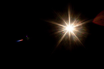 Bright lens flare light shining and leaking in dark.