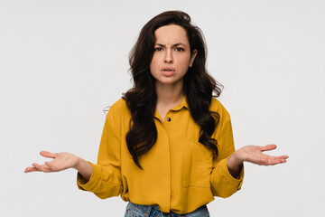 Portrait of hispanic latin questioned indecisive woman girl student with dark curly hair shrugging...