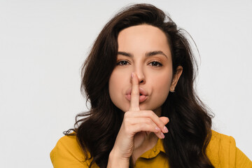 Smiling positive business woman girl student holding finger on lips mouth keep it quiet secret information showing hush shh shush gesture isolated on white studio background