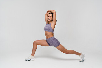 Full size young sporty athletic fitness trainer woman in tracksuit spend time in home gym train...