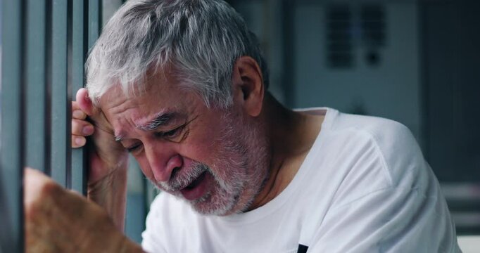Older man leaning forward against bars, defeated and broken, immersed in deep sorrow and emotional pain, dramatic portrayal of despair, aging, and the weight of life&rsquo;s struggles