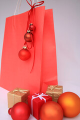 Red shopping bag with gifts and Christmas baubles