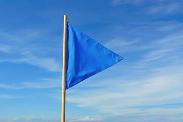 Waving Blue Triangular Flag Fluttering on a Mast in the Wind