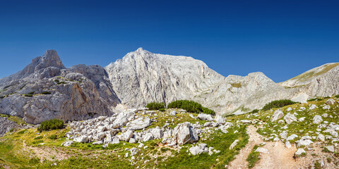 Panorama of the Pirin highlands in summer sunny day. Mt. Vihren and Dzhamdzhievi rocks, view from Kazana shelter in Pirin national park, Bulgaria.