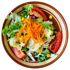 Plate contains portion of salad from fresh China cabbage, grated carrot, corn, tomato. Isolated over white background