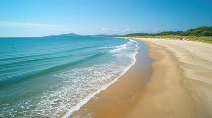 Obraz premium Serene Coastal Scene With Gentle Waves And Sandy Beach