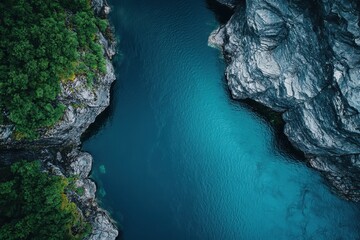 Stunning aerial view of turquoise waters surrounded by rugged cliffs and lush greenery in the heart...