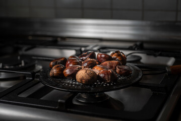 chestnuts roasted at home on a heat diffuser on gas oven top 