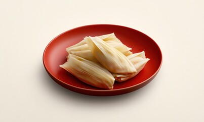 Delicious tamales served on a vibrant red plate against a soft cream background perfect for any festive occasion