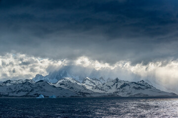 South Georgia Island. Opening in clouds and Virga reveal the mountainous and glaciated landscape.