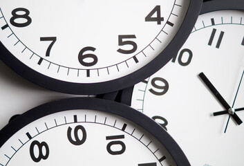 Close-Up of Multiple Black and White Analog Clocks Overlapping Each Other