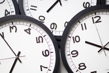 Close-Up of Multiple Black and White Analog Clocks Overlapping Each Other