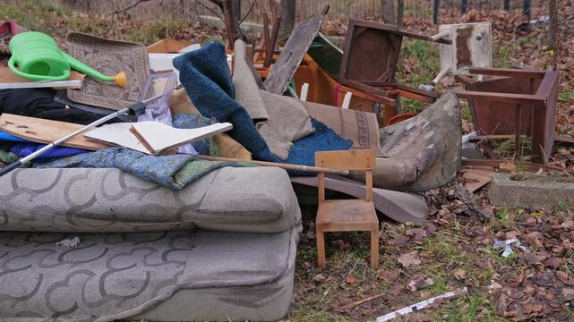 Unwanted Household Furniture and Carpets Dumped in Messy Backyard during Apartment Remodelling Redesign by New Owner