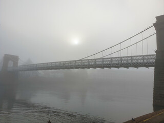 Morning walk along the river on a foggy day.