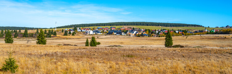 The expansive landscape of Bozi Dar Peat Bog in the Ore Mountains features rolling hills, vibrant...